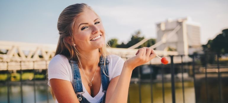 Woman smiling and holding a lollypop