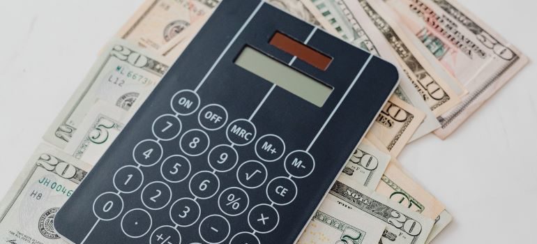 Calculator on a stack of dollar bills.